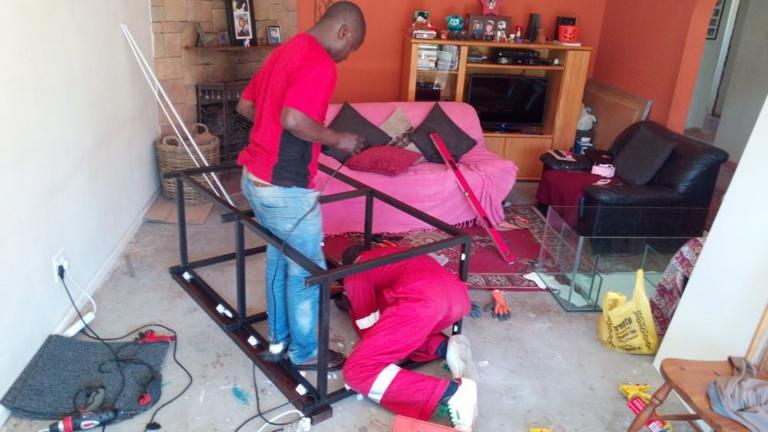 Fish Tank Boys team assembling an aquarium stand