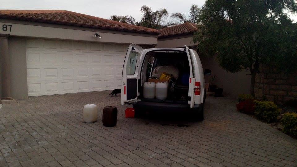 Fish Tank Boys caddy loaded with sealed drums of the client's own tank water